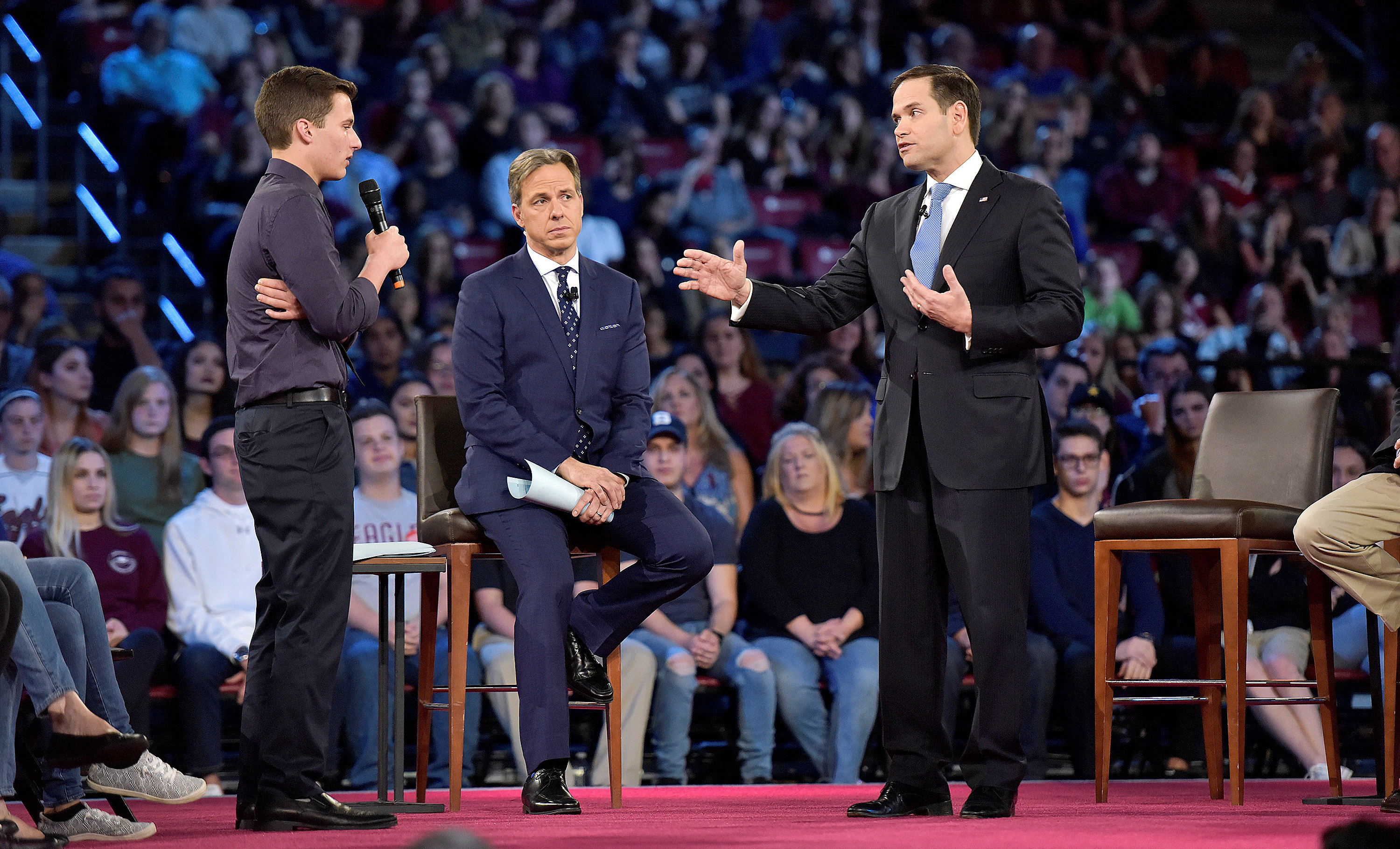 High-school shooting survivor Cameron Kasky (L) asks Senator Marco Rubio if he will continue to accept money from the NRA.