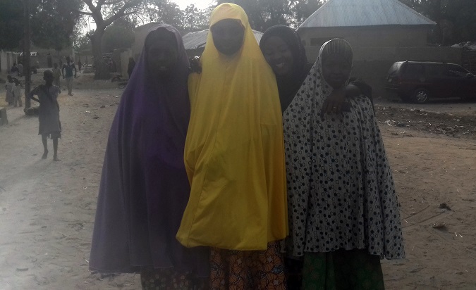 Girls who fled during the attack by Boko Haram on their school pose for a picture in Dapchi, Nigeria.