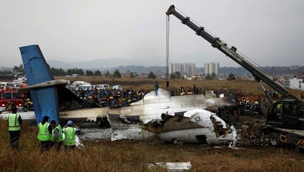 Rescue workers work at the wreckage of a U.S.-Bangla airplane after it crashed at the Tribhuvan International Airport in Kathmandu, Nepal March 12, 2018. 