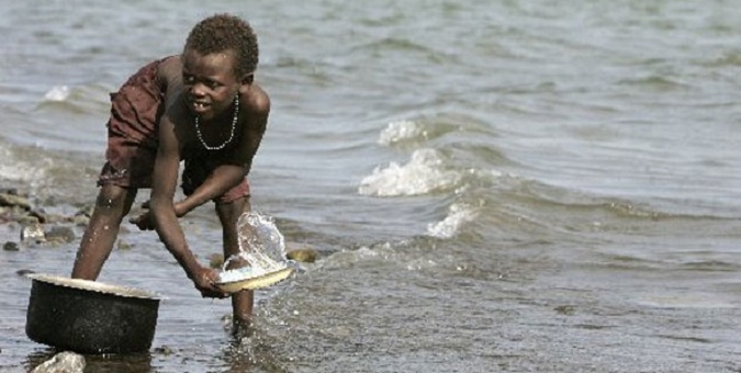 A boy fetches water from Lake Turkana. Experts say building of a dam on Omo River will produce a broad range of negative effects that will be catastrophic to people and nature.