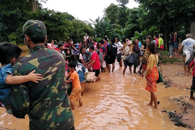 Villagers carry their belonging as they evacuate after the Xepian-Xe Nam Noy hydropower dam collapsed in Attapeu province, Laos.