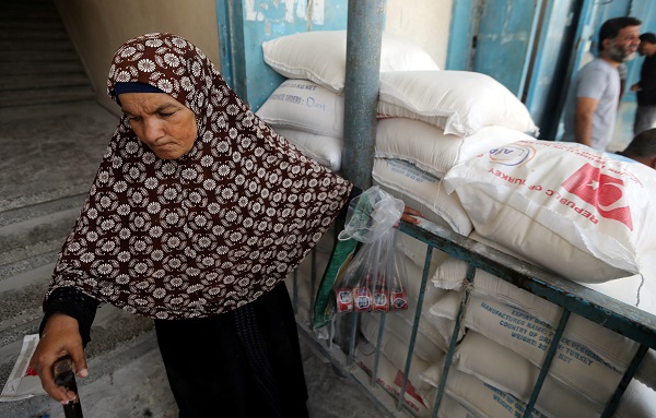 A Palestinian woman exits an aid distribution center run by the United Nations in the Gaza Strip, September 4, 2018.