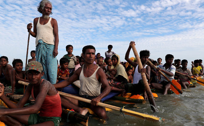 Rohingya refugees cross the Naf River with an improvised raft to reach Bangladesh in Teknaf, Bangladesh, November 12, 2017.