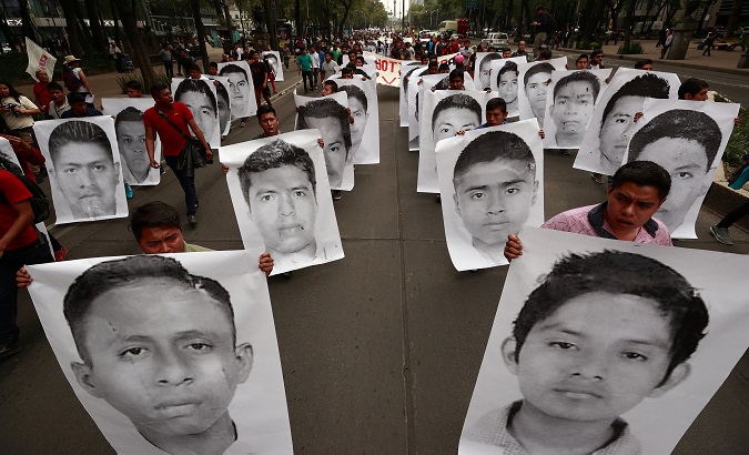 Relatives and friends of the missing students mark 43 months since their disappearance in Mexico City, April 26, 2018.