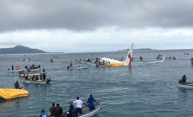 People are evacuated from an Air Niugini plane in the waters in Weno, Chuuk, Micronesia on September 28, 2018.