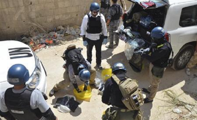 United Nations chemical weapons experts prepare before collecting samples from one of the sites of an alleged chemical weapons attack in Damascus' suburb of Zamalka August 29, 2013.