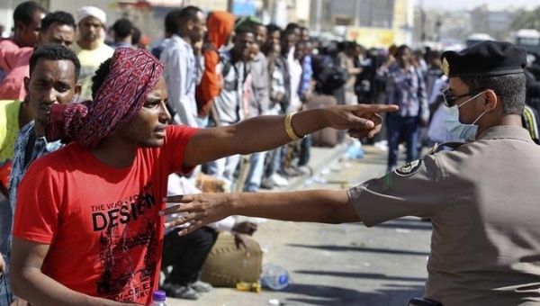 An Ethiopian worker argues with a Saudi security officer in Riyadh, where thousands of African workers gathered seeking repatriation after two people were killed in riots following a Saudi visa crackdown. 