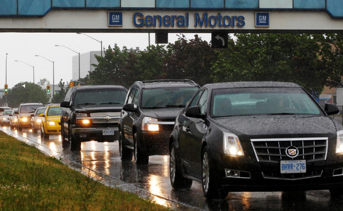 A line up of cars is seen on a road after a shift change at the General Motors Car assembly plant in Oshawa, June 1, 2012.