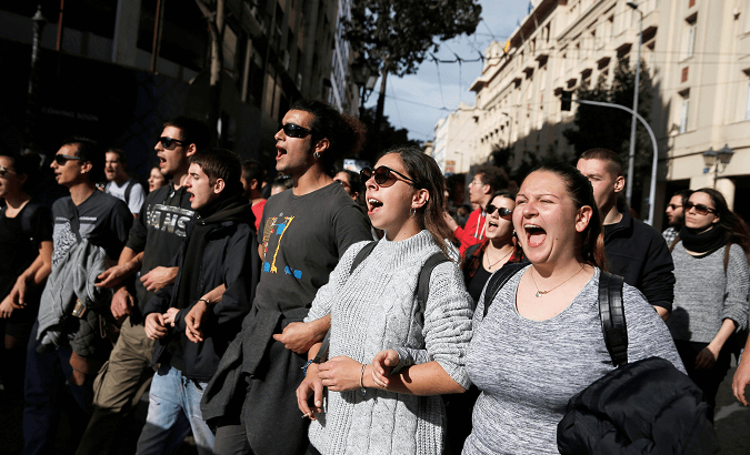 Protesters shout slogans during a demonstration marking a 24-hour strike, in Athens.