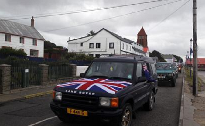 People drive their cars on Ross road with Union Jack and Falkland Islands flags during a parade in Stanley March 10, 2013.