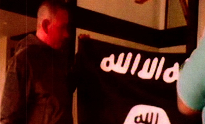 Kang holding the Islamic State Flag after pledging allegiance to the Islamic State. Kang is charged with trying to provide material support to Islamic State extremists.
