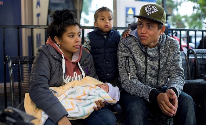 Jose Miguel and Maryuri Ortiz, with their sons, waiting in a bus station in San Diego, California on Dec. 5, 2018.