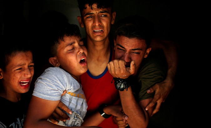 Relatives of a Palestinian, who was killed at the Israel-Gaza border, react at a hospital in Gaza City, June 18, 2018.