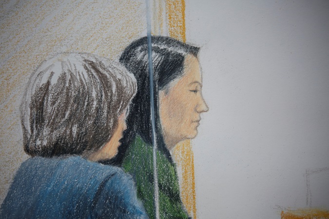 Huawei CFO Meng Wanzhou, who was arrested on an extradition warrant, appears at her B.C. Supreme Court bail hearing along with a translator, in a drawing in Vancouver, British Columbia, Canada December 7, 2018. REUTERS/Jane Wolsak.