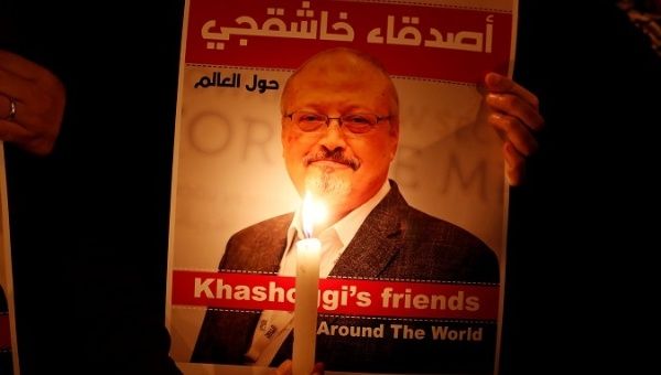 A demonstrator holds a poster with a picture of Saudi journalist Jamal Khashoggi outside the Saudi Arabia consulate in Istanbul, Turkey October 25, 2018. 