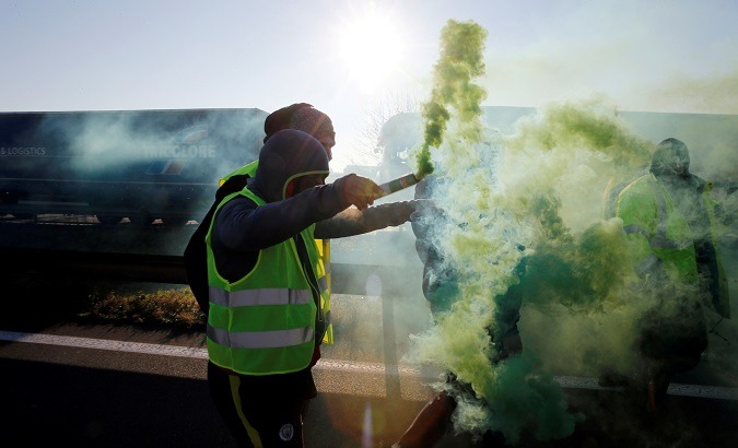People wearing yellow vests, a symbol of a French nationwide protest of higher fuel prices, block the Paris-Brussels motorway in Haulchin, France, Nov 17, 2018.