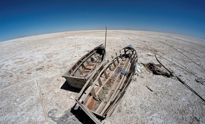 Boats are seen on the dried lake Poopo affected by climate change, in the Oruro Department, Bolivia, Sep. 1, 2017.
