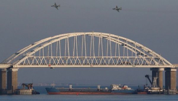 Russian jet fighters fly over a bridge connecting the Russian mainland with the Crimean Peninsula, Nov. 25, 2018.