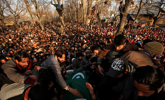 People gather around the body of Zahoor Ahmad, a pro-freedom fighter killed by Indian soldiers, at his funeral in Sirnoo village in south Kashmir's, Dec. 15, 2018.