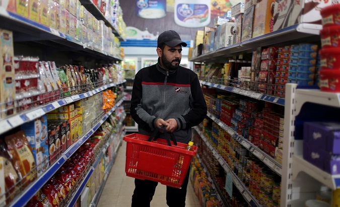 Palestinian man Anwar Aziza, 32, an unemployed father, shops in a supermarket in Deir al-Balah in the central Gaza Strip December 17, 2018.