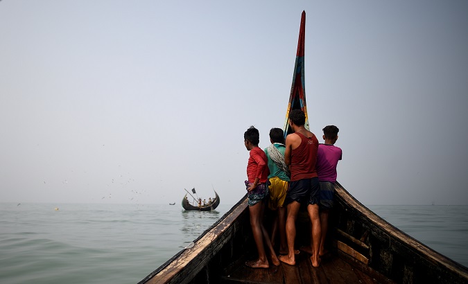 Rohingya refugees crew a fishing boat in the Bay of Bengal near Cox's Bazaar, Bangladesh, Mar. 24, 2018.