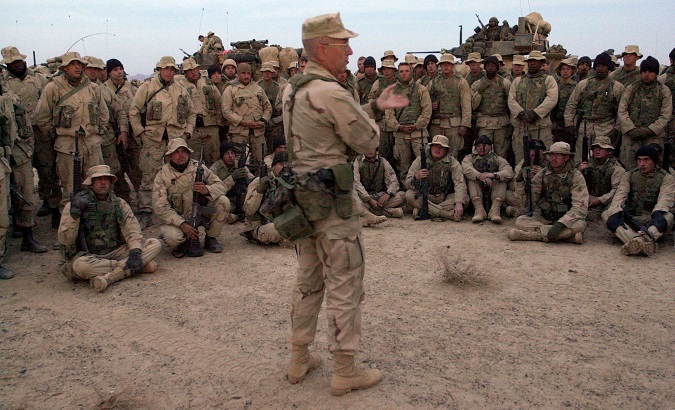 Brigadier General James Mattis talks with U.S. Marines of the 15th and 26th Marine Expeditionary Unit prior to their departing in a 40 plus vehicle convoy from a staging area to take control of the airfield in Kandahar, Afghanistan, December 14, 2001.
