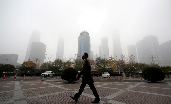 A man wearing a mask walks on a polluted day in Beijing, China, Nov. 14, 2018.