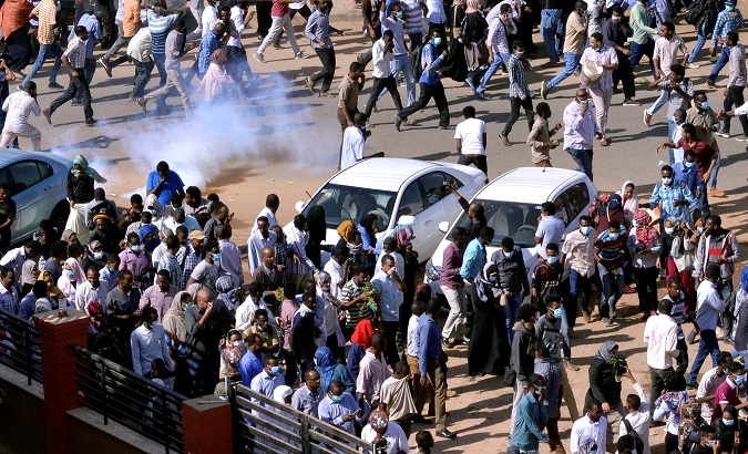 Sudanese demonstrators run from teargas during anti-government protests in Khartoum.