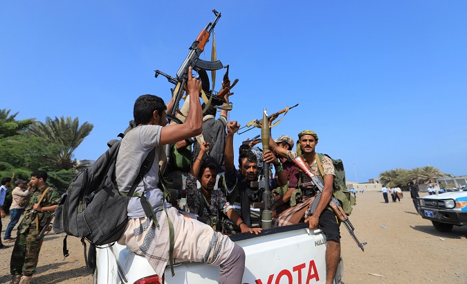 Houthi militants ride on the back of a truck as they withdraw from Hodeidah, part of a U.N.-sponsored peace agreement.