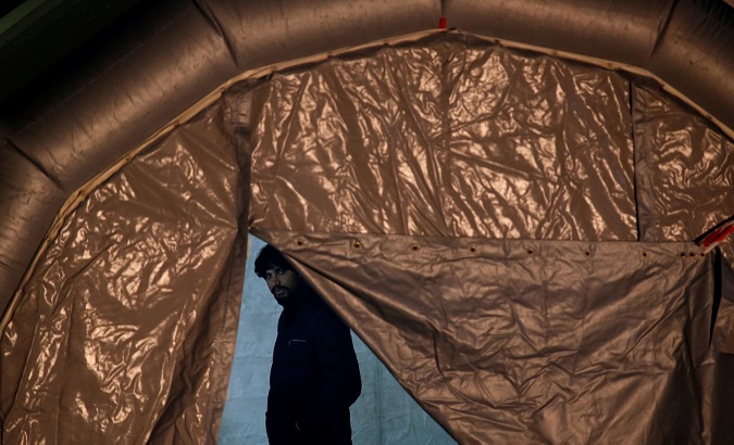 A migrant, part of a group of 69 migrants rescued 117 nautical miles south west of Malta by the Armed Forces of Malta (AFM), waits to be processed after arriving at the AFM Maritime Squadron base in Valletta's Marsamxett Harbour, Malta December 30, 2018