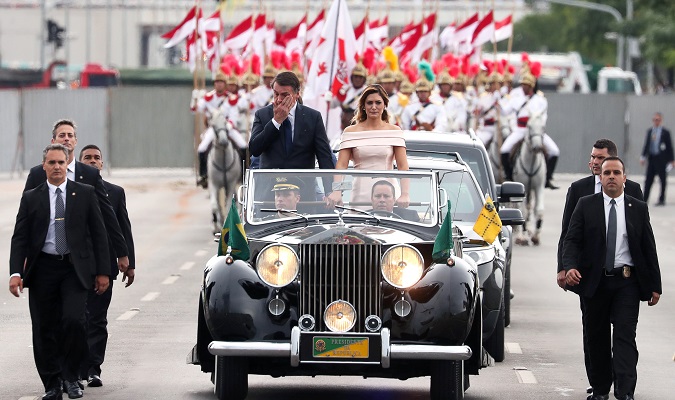 Brazil's new President Jair Bolsonaro reacts as he drives past before his swear-in ceremony, in Brasilia, Brazil Jan. 1, 2019.