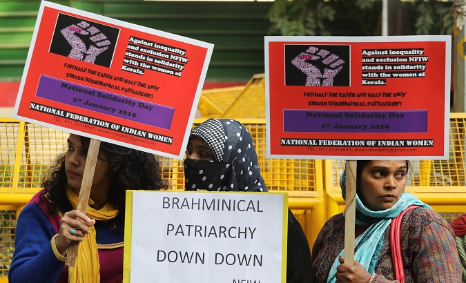 Women display placards in solidarity of the 