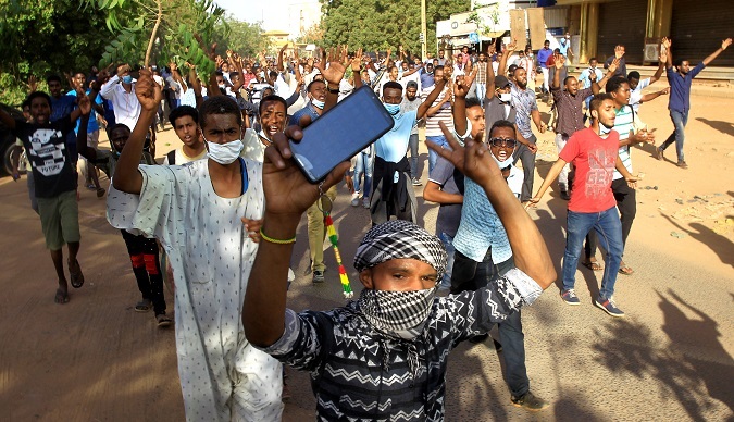 Sudanese demonstrators chant slogans as they march along the street during anti-government protests in Khartoum, Sudan Dec. 25, 2018.