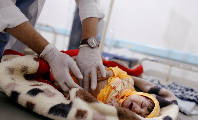 A doctor checks a cholera-infected child at a hospital in Sanaa, Yemen, Nov. 12, 2018.