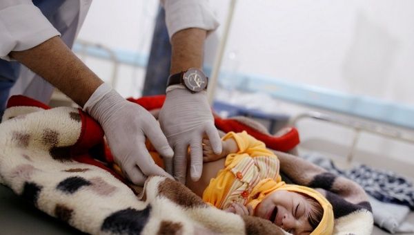 A doctor checks a cholera-infected child at a hospital in Sanaa, Yemen, Nov. 12, 2018.