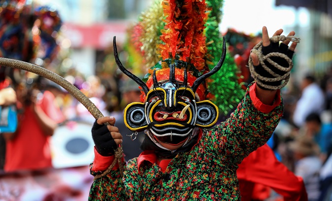 People dressed as devils celebrate the new year in Pillaro, Ecuador, Jan. 2, 2018.