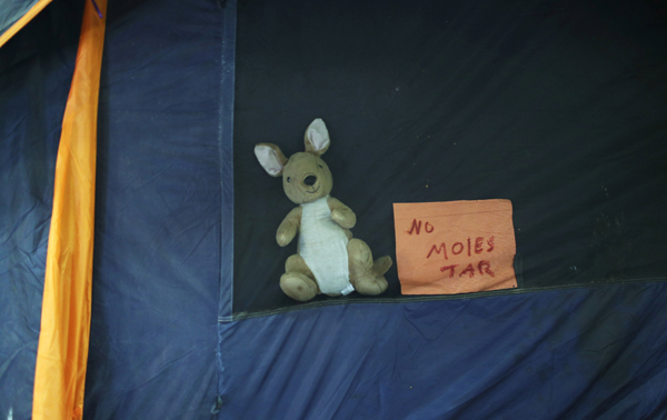 A note on a tent in the migrant caravan traversing Central and North America reads 'Do not disturb.'