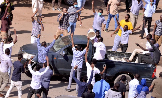 Sudanese demonstrators chant slogans as they march  during anti-government protests in Khartoum, Dec. 25.