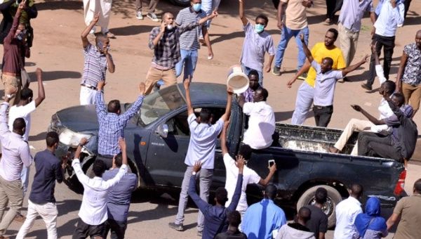 Sudanese demonstrators chant slogans as they march  during anti-government protests in Khartoum, Dec. 25.
