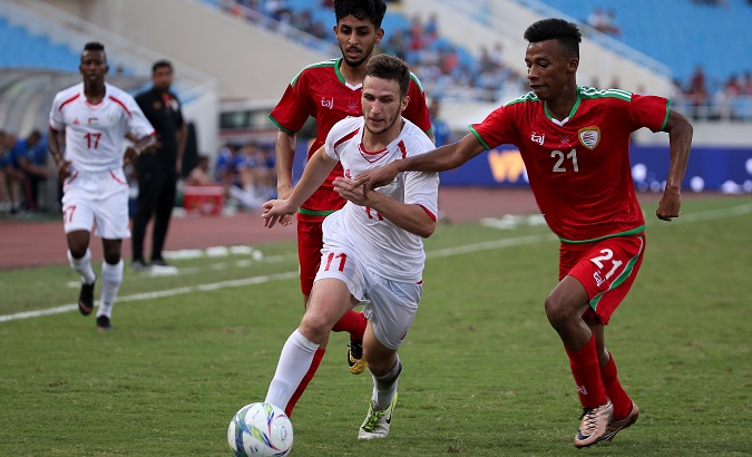 Oman fights for the ball with Palestine at the Vietnam Football Federation International U23 tournament, 2018.