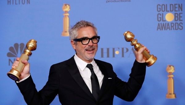 Alfonso Cuaron poses backstage with his Best Director - Motion Picture and Best Motion Picture - Foreign Language for 