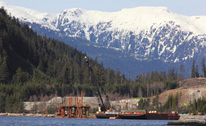 Cranes work in the water at the Kitimat LNG site near Kitimat, in northwestern British Columbia on April 13, 2014.