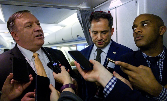 U.S. Secretary of State Mike Pompeo speaks with the press as two members of his staff look on as he flies to the Middle East on January 7, 2019. Andrew Caballero-Reynolds/Pool via REUTERS