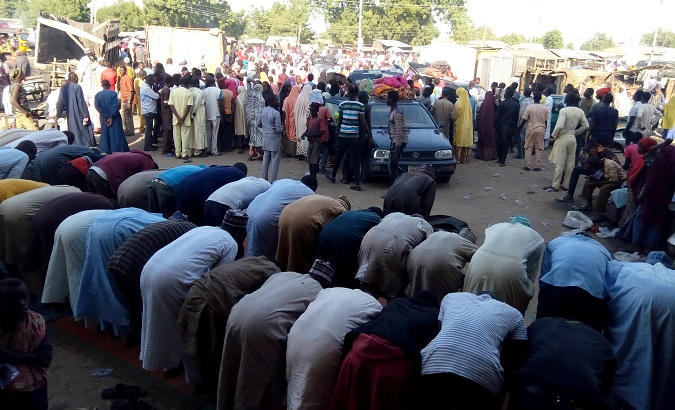 People pray as Nigerians who fled the town of Baga arrive in Maiduguri, Nigeria, December 29, 2018.