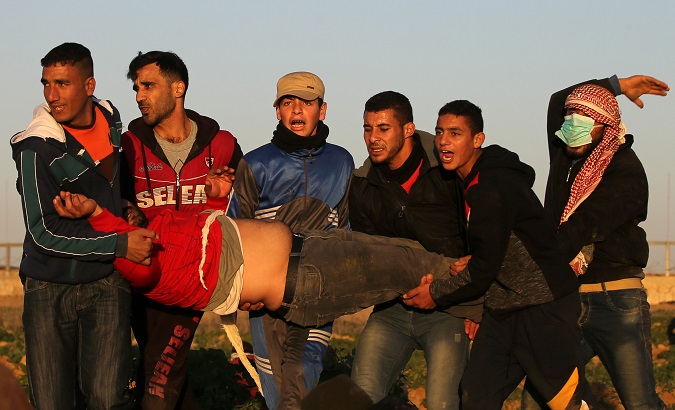 Palestinians evacuate a demonstrator during a protest at the Israel-Gaza border fence, January 11, 2019.