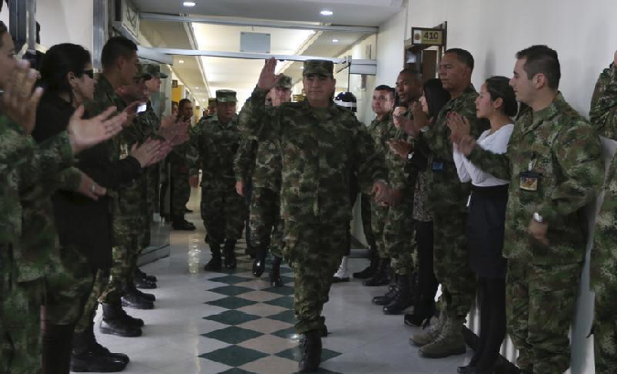 General Leonardo Barrero (C), commander of Colombia's armed forces, waves at troops as he leaves the Ministry of Defense Building in Bogota, February 18