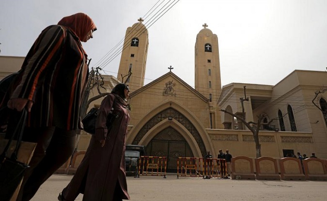 Women pass by the Coptic church that was bombed on Sunday in Tanta, Egypt, April 10, 2017.