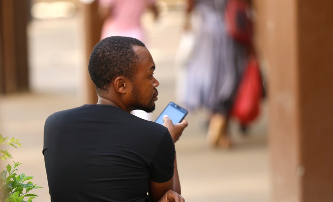 A man checks his mobile phone in Harare, Zimbabwe, Jan. 18, 2019.