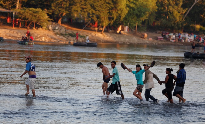 A caravan of migrants from Honduras en route to the United States, cross the Suchiate river to Mexico from Tecun Uman.