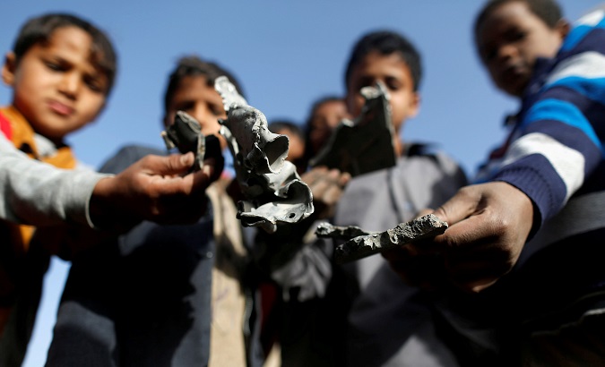 Boys hold missile shrapnel they collected from the site of a Saudi-led air strike in the Houthi-held capital Sanaa, Yemen Jan. 20, 2019.